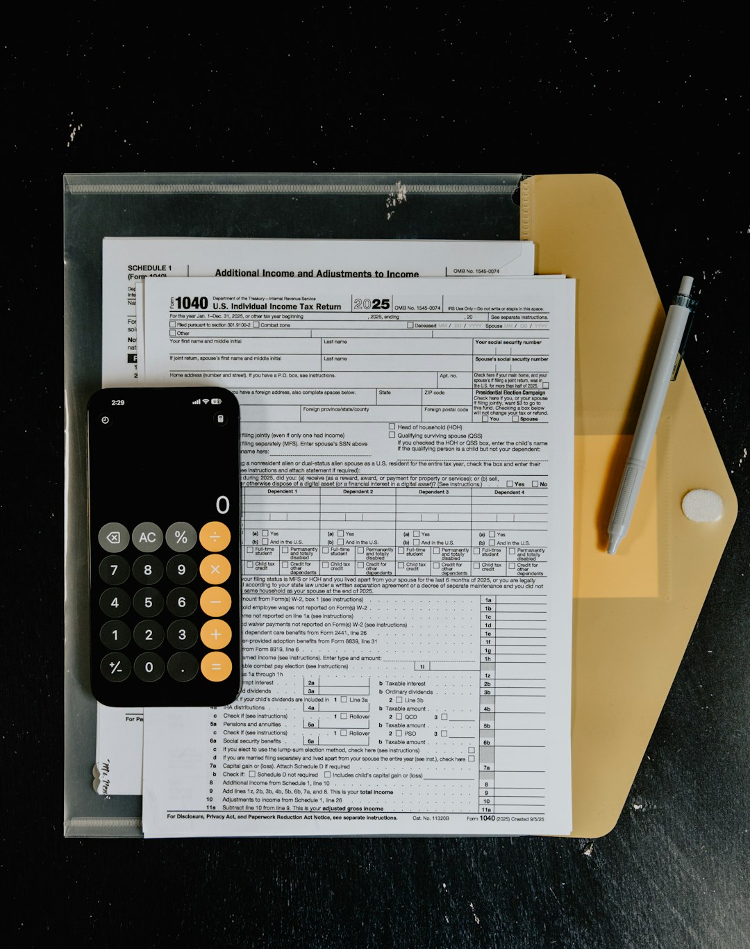 tax-forms-with-calculator-and-pen-on-desk-s0ii1aqa9gi